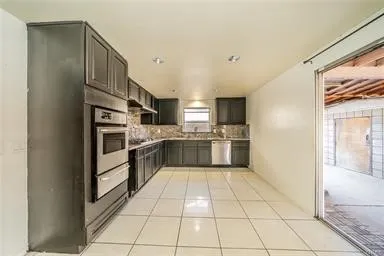 a large kitchen with cabinets and stainless steel appliances