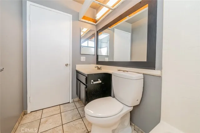 a white toilet sitting in a bathroom next to a window