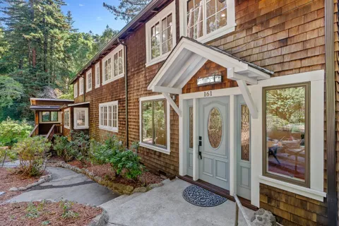 a living room with furniture and large windows