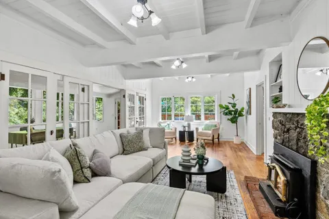 a view of a livingroom with furniture and hardwood floor