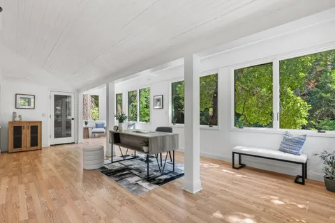 a view of a dining room with furniture window and wooden floor