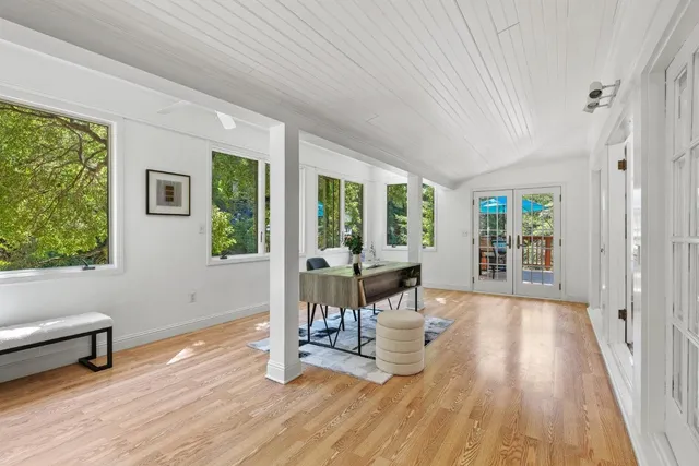 a room with a wooden floor and a window
