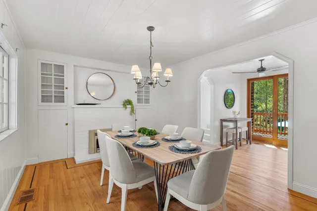 a bedroom with a large bed a large window and wooden floor