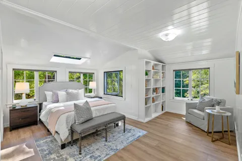 a large bedroom with a large bed and a large window