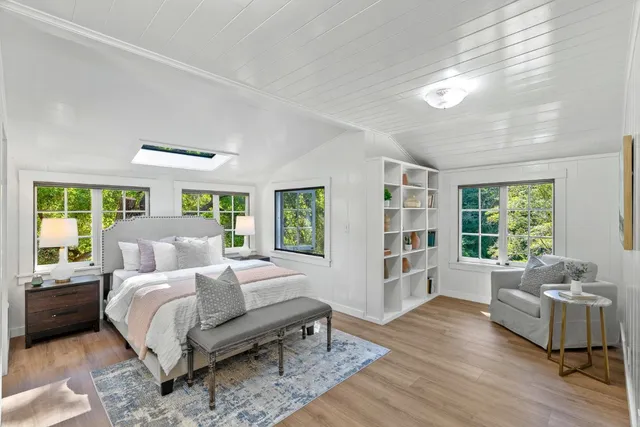 a large bedroom with a large bed and a large window