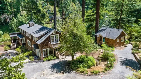 an aerial view of a house with swimming pool patio and outdoor seating
