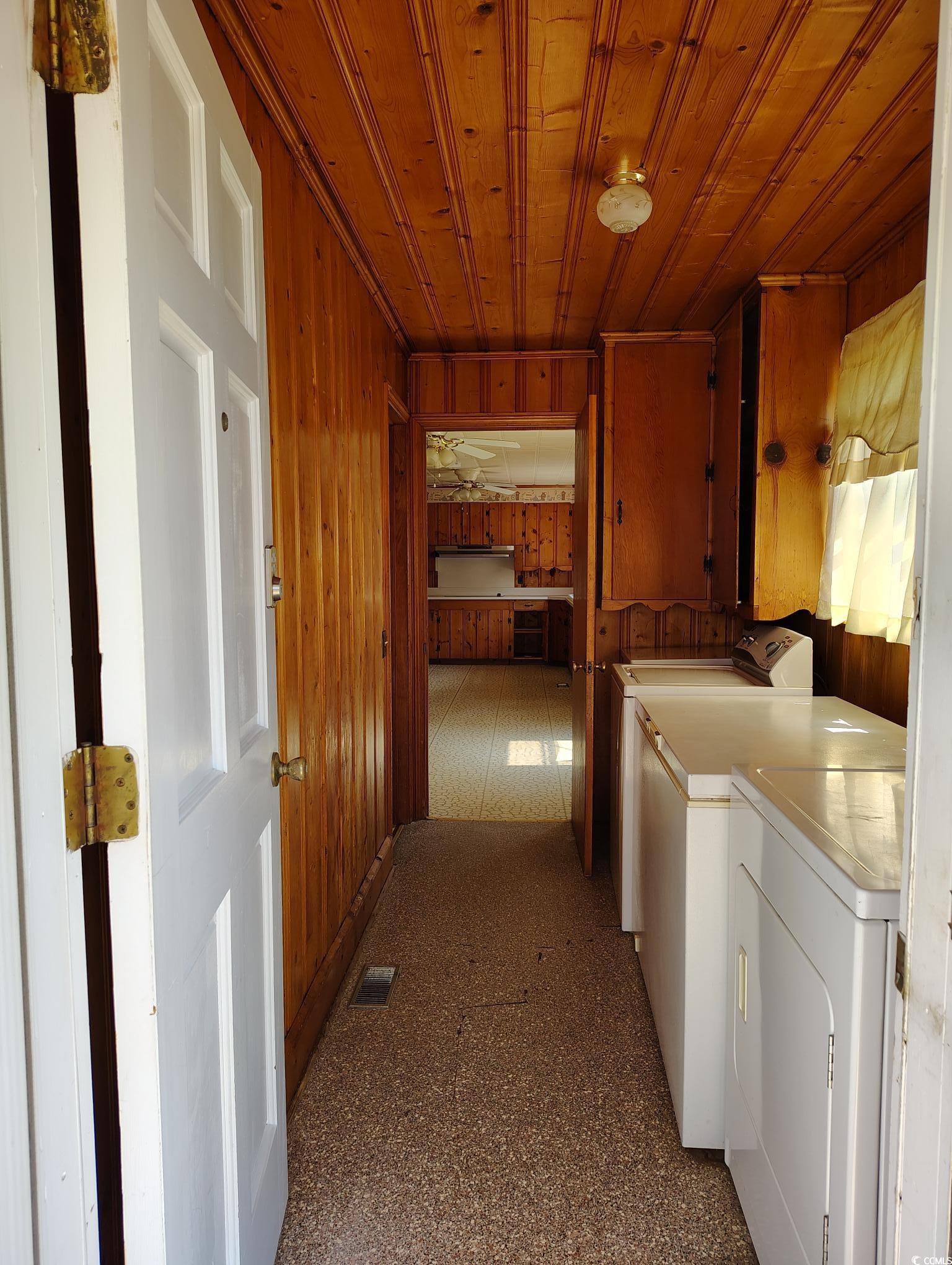 1375 Kenny Jordan Road Tabor City, NC 28463 - Photo 13 of 15 Clothes washing area with cabinet space, wooden walls, visible vents, washer and clothes dryer, and wood ceiling