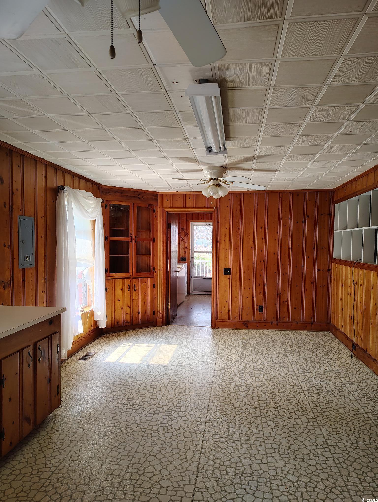1375 Kenny Jordan Road Tabor City, NC 28463 - Photo 6 of 15 Spare room with light floors, visible vents, wooden walls, washer / dryer, and electric panel
