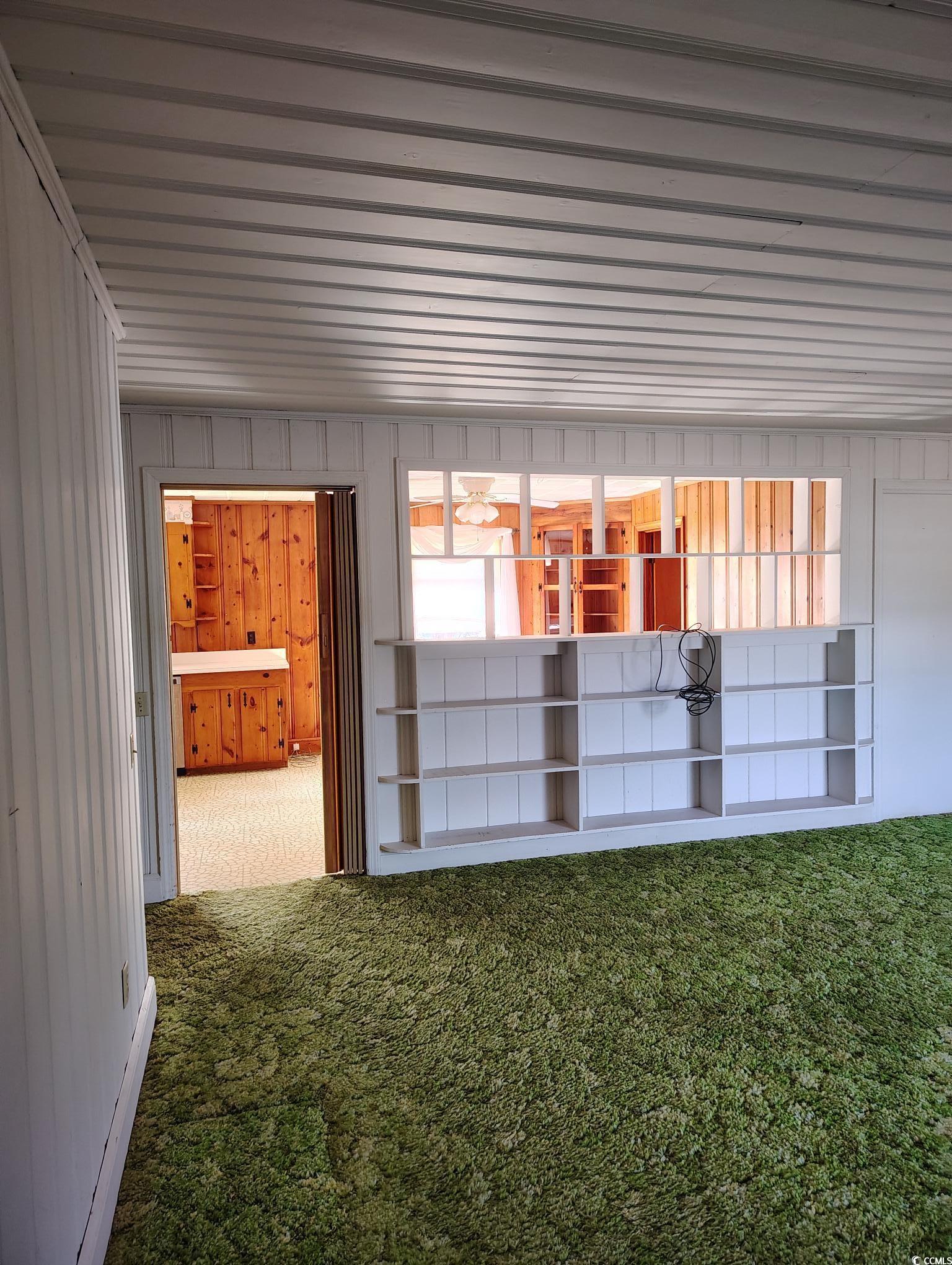 1375 Kenny Jordan Road Tabor City, NC 28463 - Photo 8 of 15 Interior space featuring wood walls and carpet