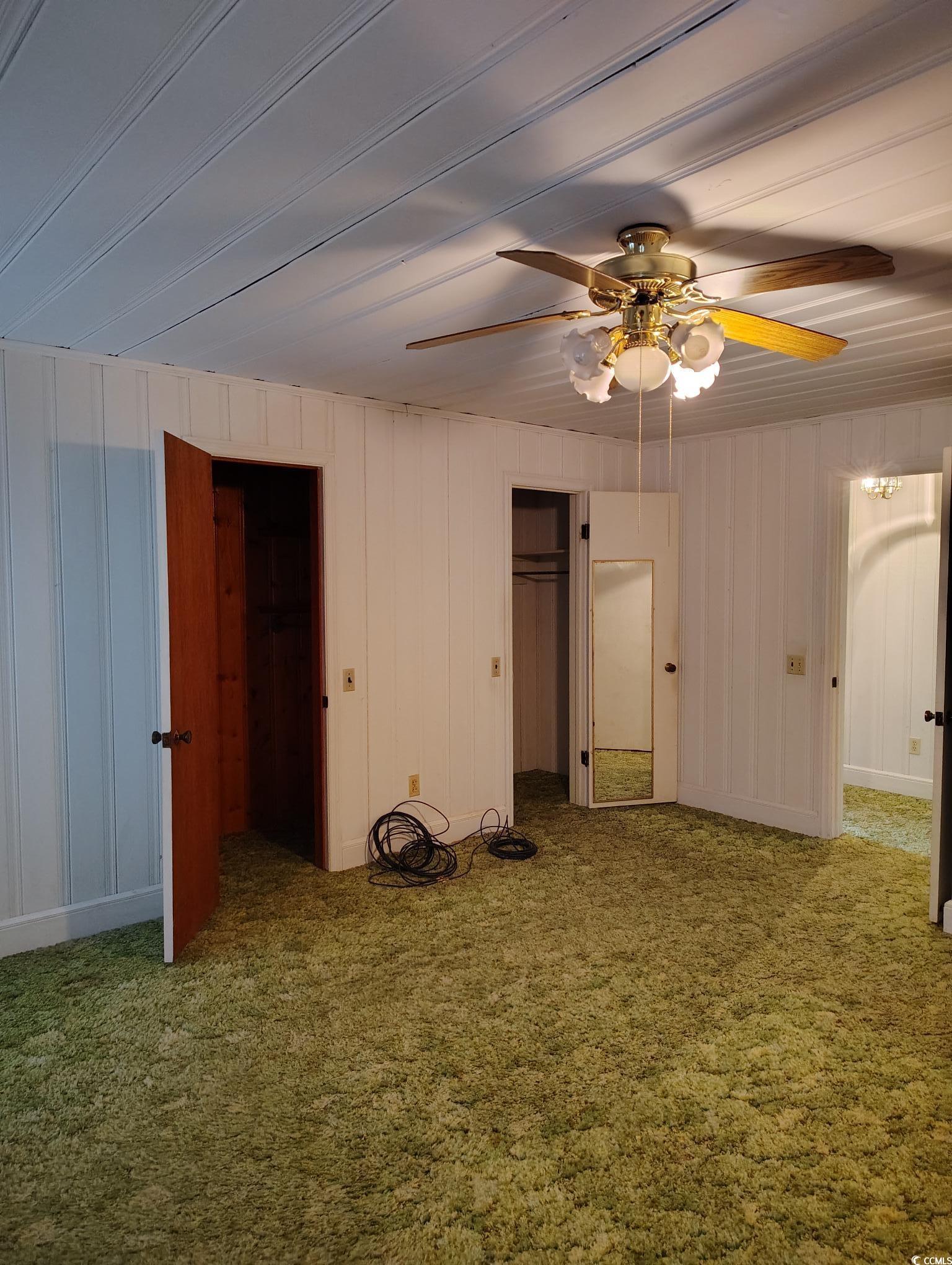 1375 Kenny Jordan Road Tabor City, NC 28463 - Photo 9 of 15 Unfurnished bedroom featuring a ceiling fan and carpet