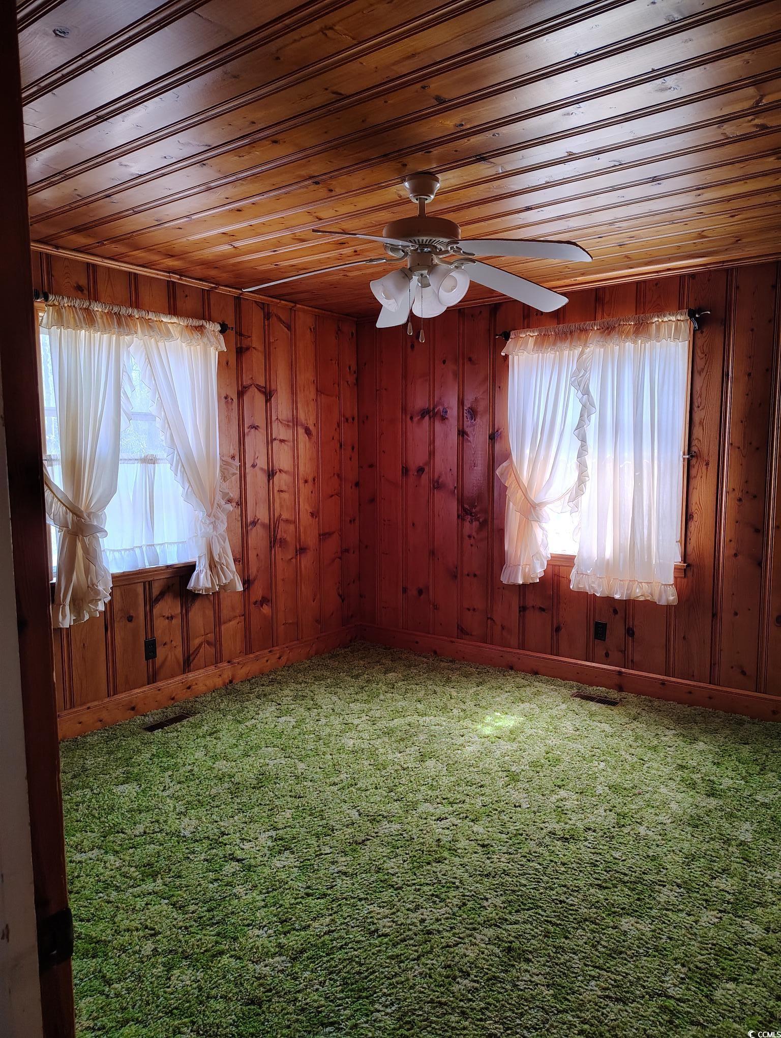 1375 Kenny Jordan Road Tabor City, NC 28463 - Photo 10 of 15 Unfurnished room featuring wood ceiling, carpet flooring, and wood walls