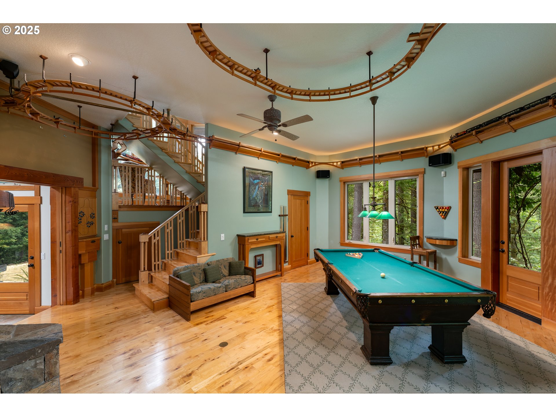 22091 South Ridge Road Oregon City, OR 97045 - Photo 18 of 48 a room with pool table two windows and a wooden floor