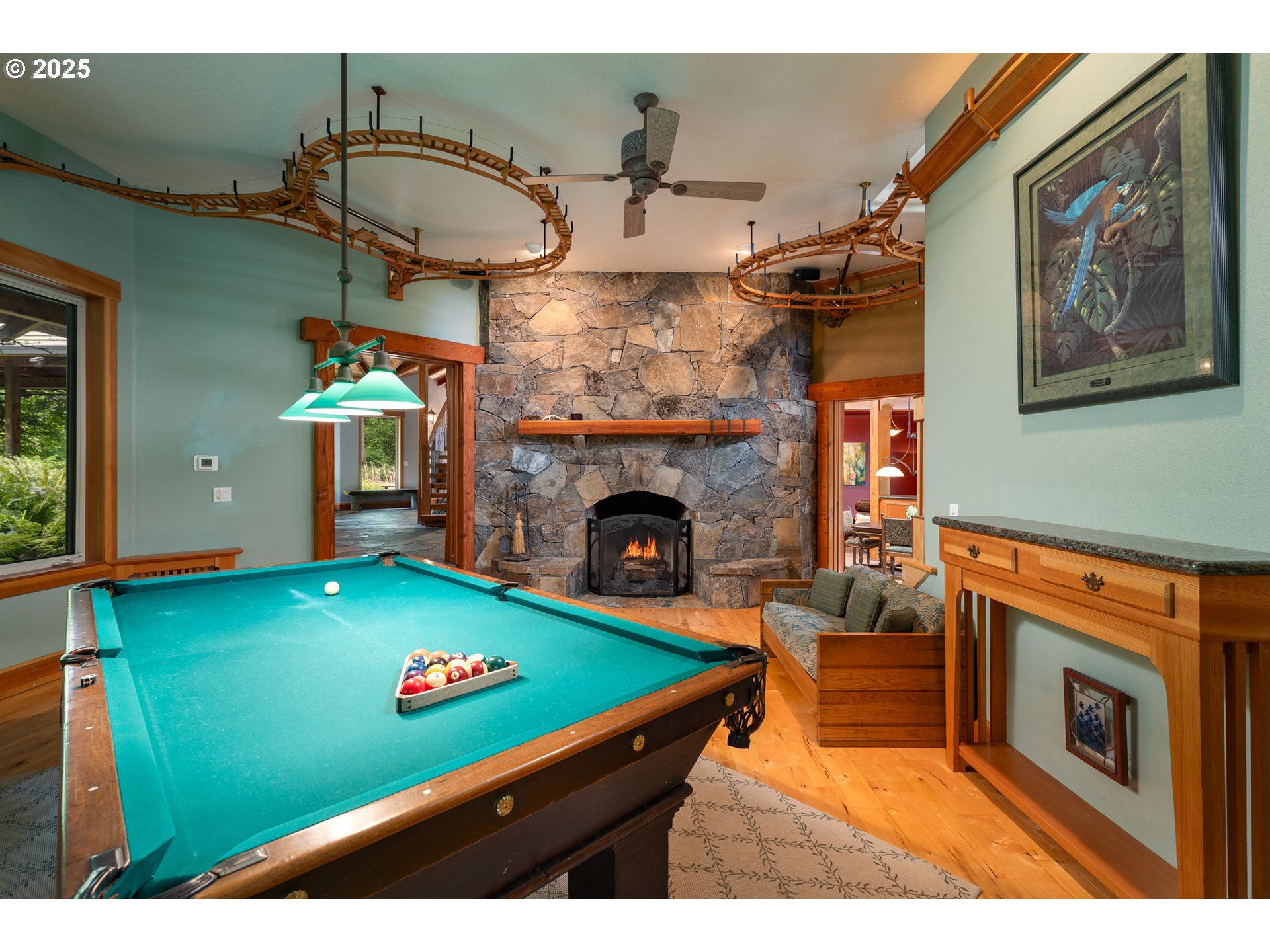 22091 South Ridge Road Oregon City, OR 97045 - Photo 19 of 48 a living room with furniture pool table and a fireplace