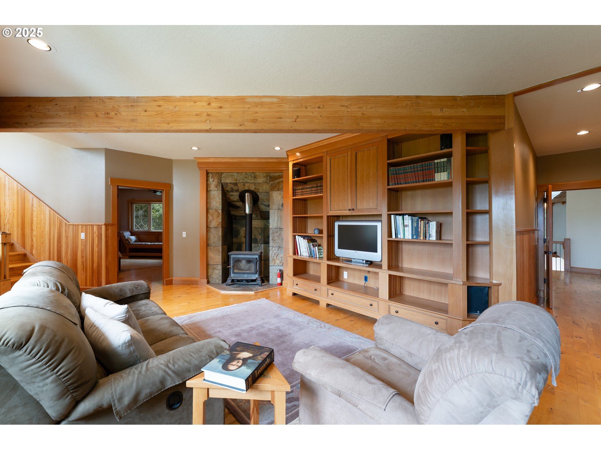 22091 South Ridge Road Oregon City, OR 97045 - Photo 23 of 48 a living room with furniture a flat screen tv and a book shelf