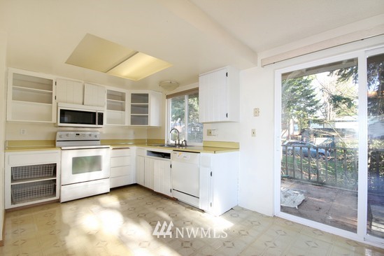 21705 6th Avenue West Bothell, WA 98021 - Photo 2 of 15 a kitchen with granite countertop white cabinets and white appliances