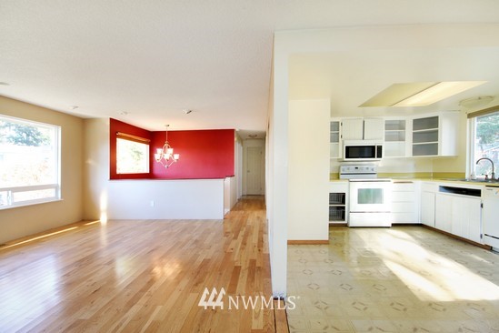 21705 6th Avenue West Bothell, WA 98021 - Photo 4 of 15 a view of a kitchen with kitchen island a sink wooden floor and stainless steel appliances