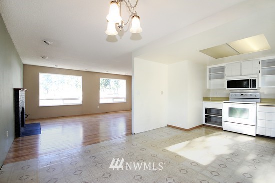 21705 6th Avenue West Bothell, WA 98021 - Photo 5 of 15 a view of a kitchen with microwave and stove top oven