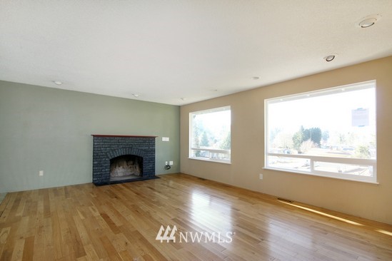 21705 6th Avenue West Bothell, WA 98021 - Photo 7 of 15 a view of empty room with wooden floor and a fireplace