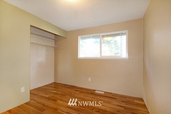 21705 6th Avenue West Bothell, WA 98021 - Photo 8 of 15 a view of an empty room with window and wooden floor