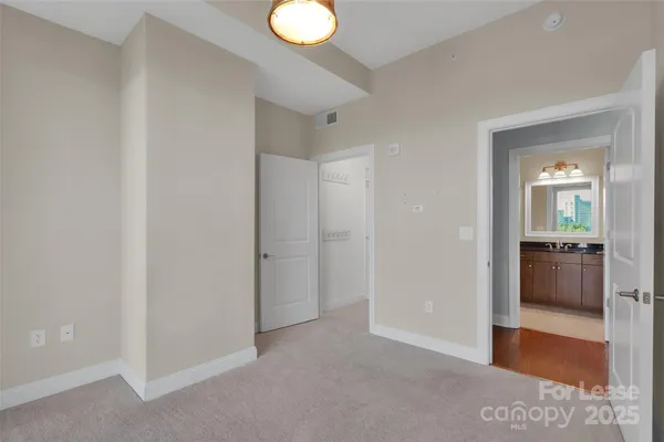 a view of a room with a hallway and a livingroom with wooden floor