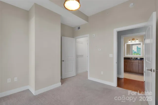 a view of a room with a hallway and a livingroom with wooden floor