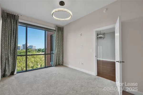 an empty room with sliding door and mountain view