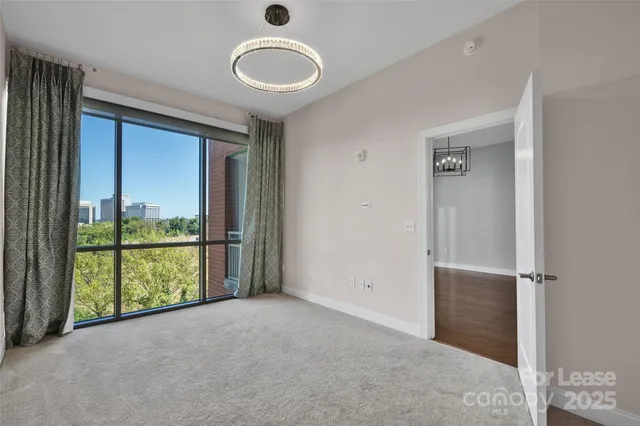 an empty room with sliding door and mountain view