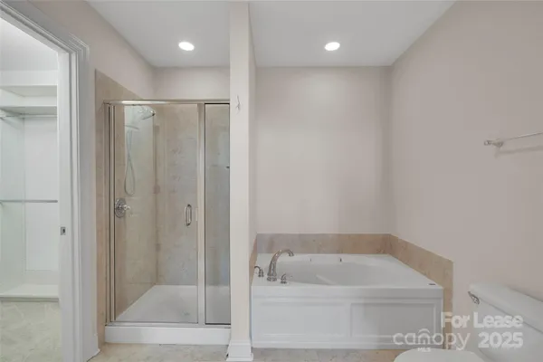 a bathroom with a tub a sink and a shower