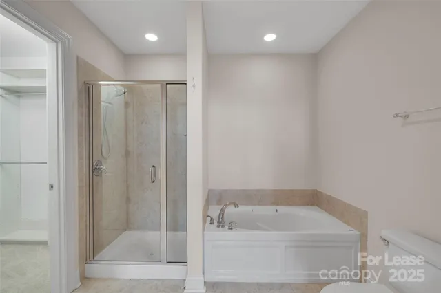 a bathroom with a tub a sink and a shower