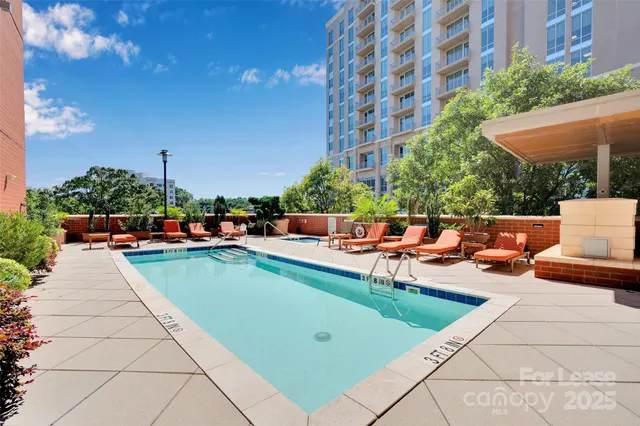 a view of swimming pool with outdoor seating and plants