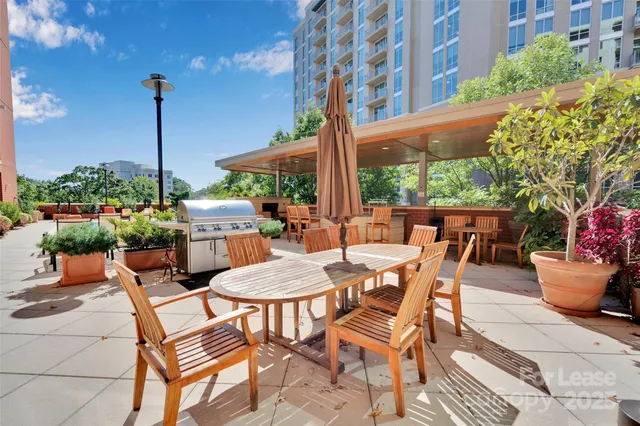 a view of a patio with a table and chairs and potted plants