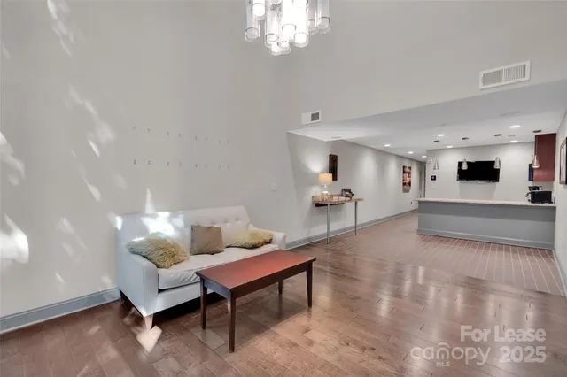a living room with furniture and a chandelier