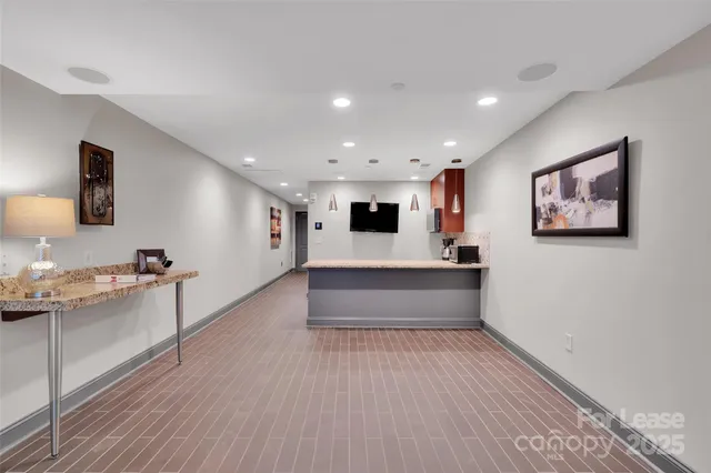 a view of a living room with furniture and a flat screen tv