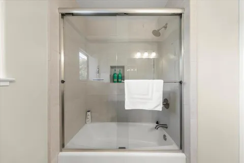 a bedroom with a bed and a large window
