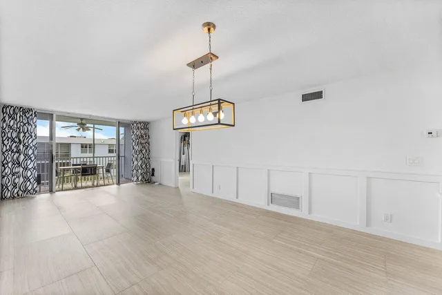 a bathroom with a granite countertop sink mirror vanity and toilet