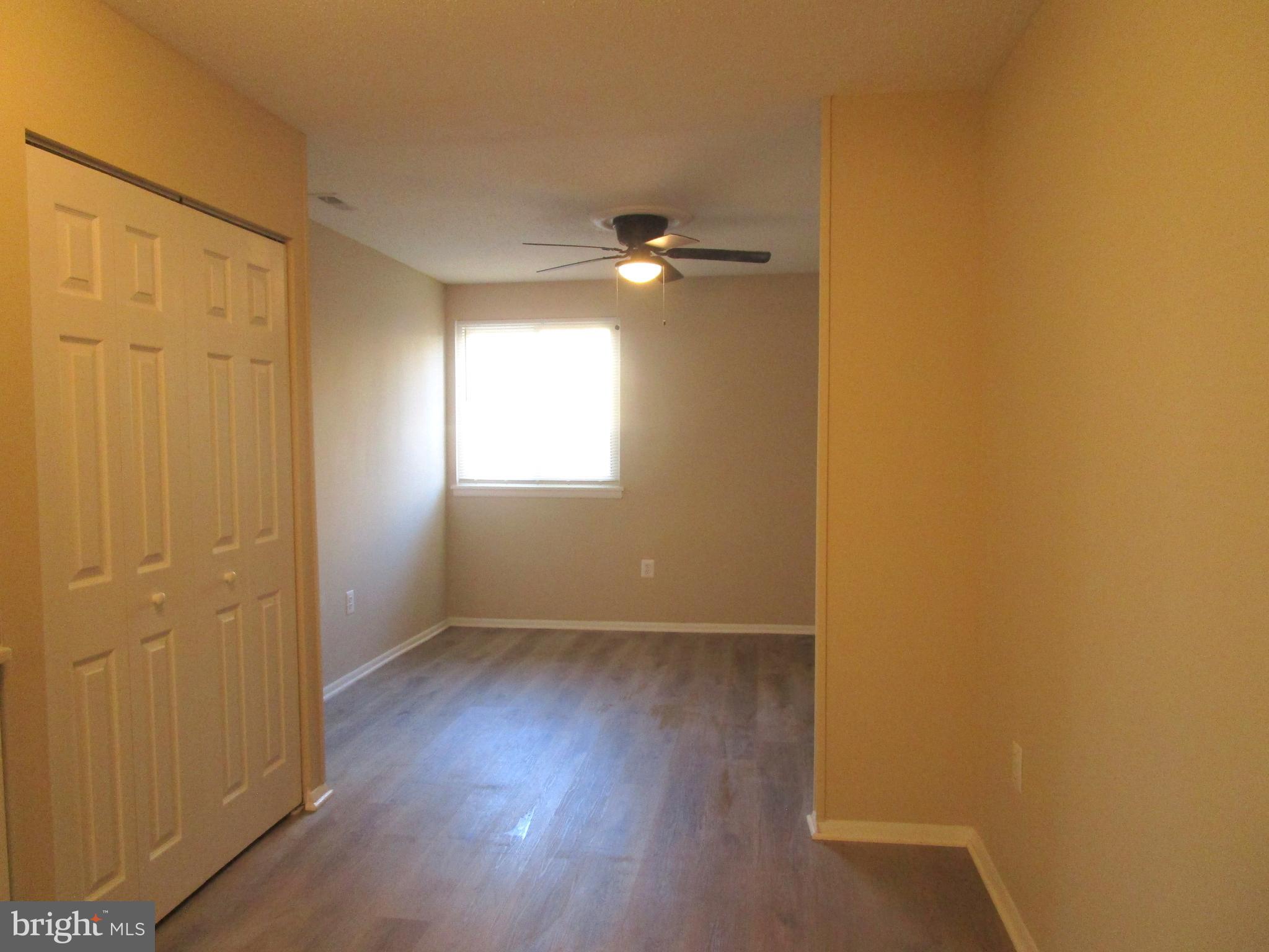 7291 E Coachlight Court Frederick, MD 21703 - Photo 11 of 19 an empty room with wooden floor and windows