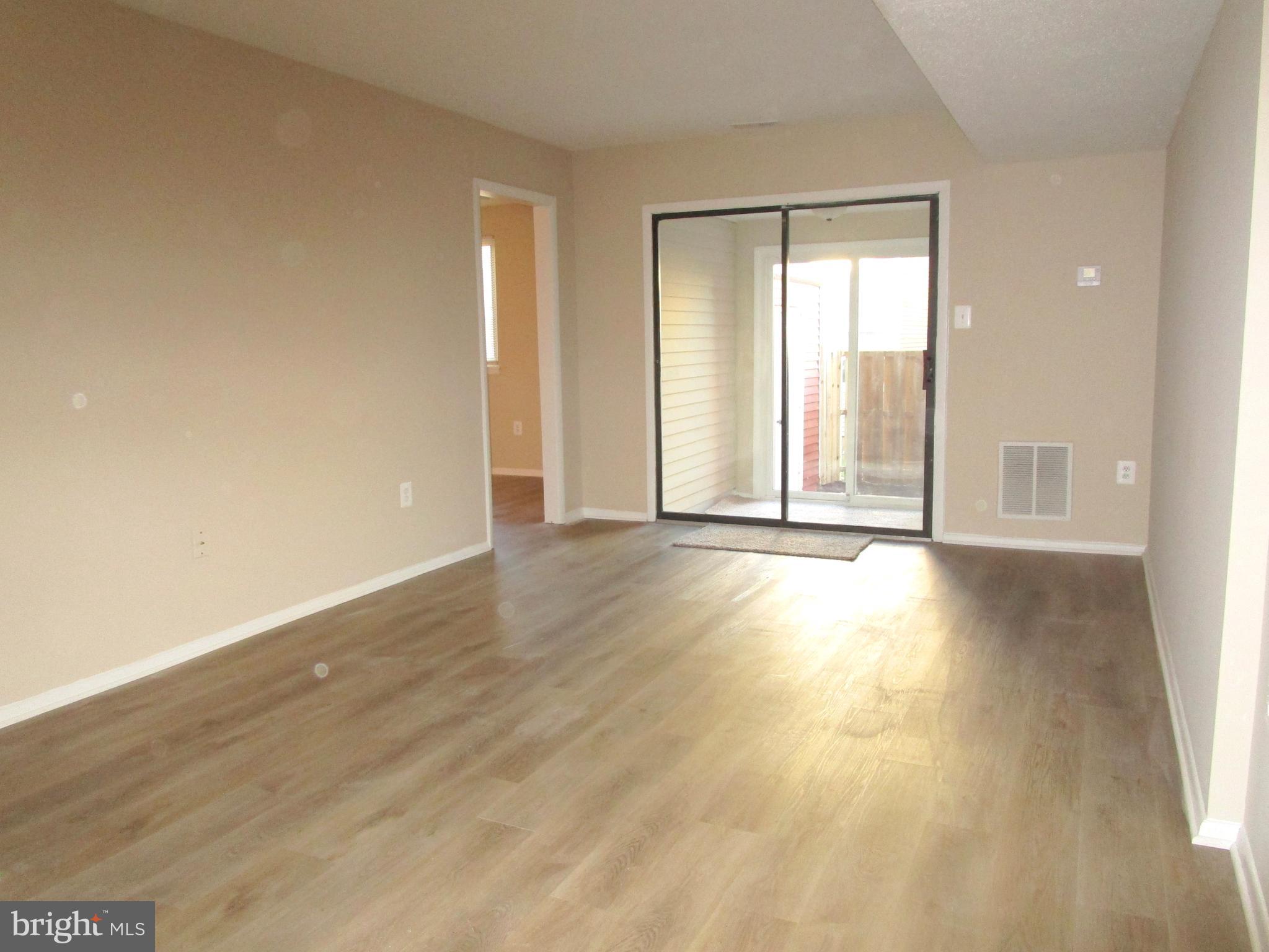 7291 E Coachlight Court Frederick, MD 21703 - Photo 3 of 19 wooden floor in an empty room with a window