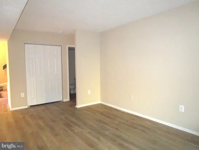 a view of an empty room and wooden floor