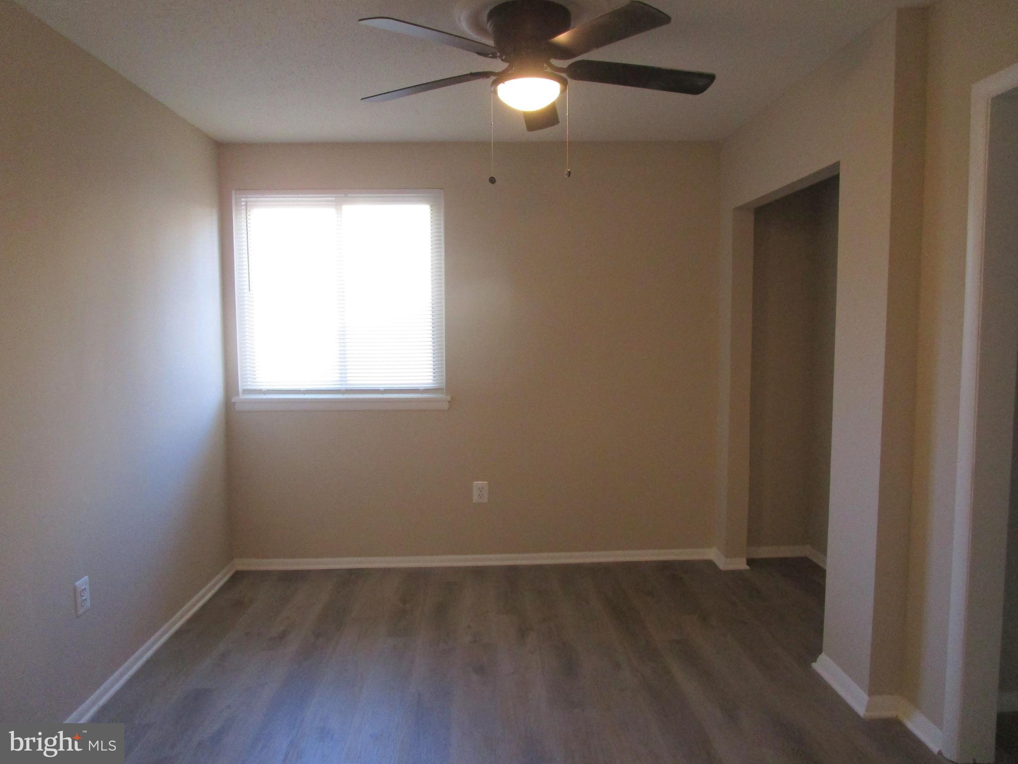 7291 E Coachlight Court Frederick, MD 21703 - Photo 5 of 19 an empty room with wooden floor and windows