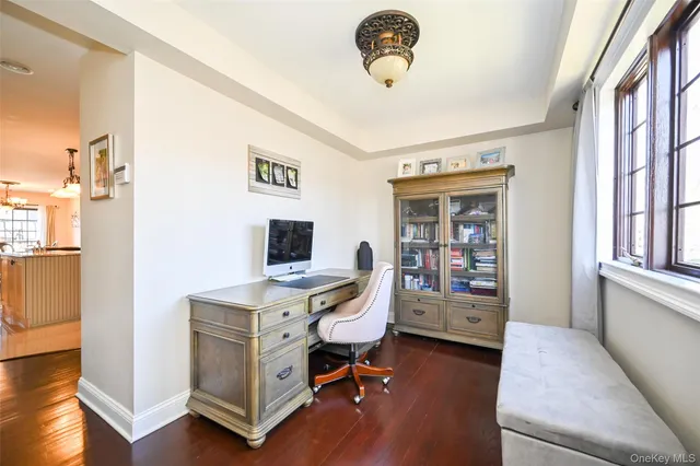 a view of a workspace with furniture and a window