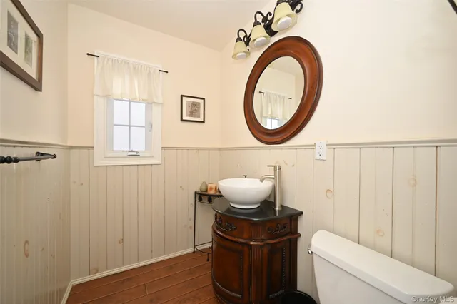 a bathroom with a toilet a sink and a mirror