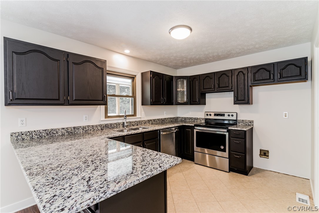 4900 North Courthouse Road Providence Forge, VA 23140 - Photo 25 of 50 a kitchen with stainless steel appliances granite countertop a sink stove microwave and refrigerator