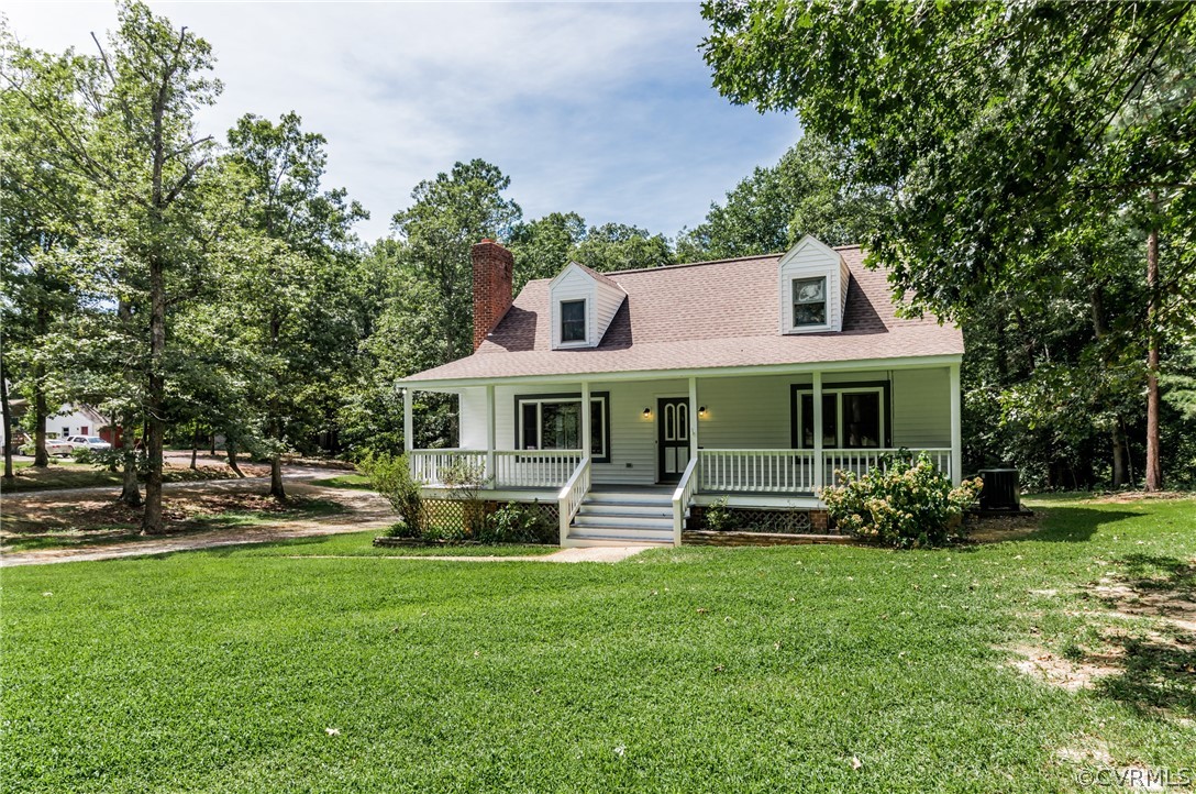 4900 North Courthouse Road Providence Forge, VA 23140 - Photo 6 of 50 a front view of a house with a yard table and chairs