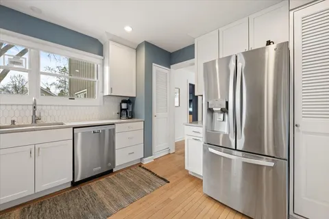 a kitchen with stainless steel appliances a refrigerator sink and cabinets