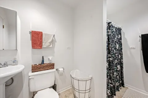 a white toilet sitting next to a bathroom sink
