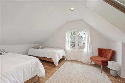 a bedroom with two beds and a couch