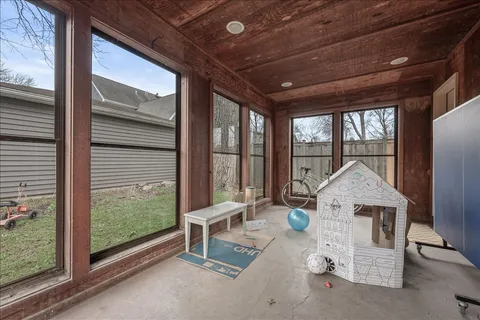 a wooden bench sitting in front of a building