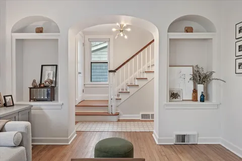 a view of entryway and hall with wooden floor