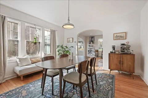a view of a dining room with furniture and wooden floor