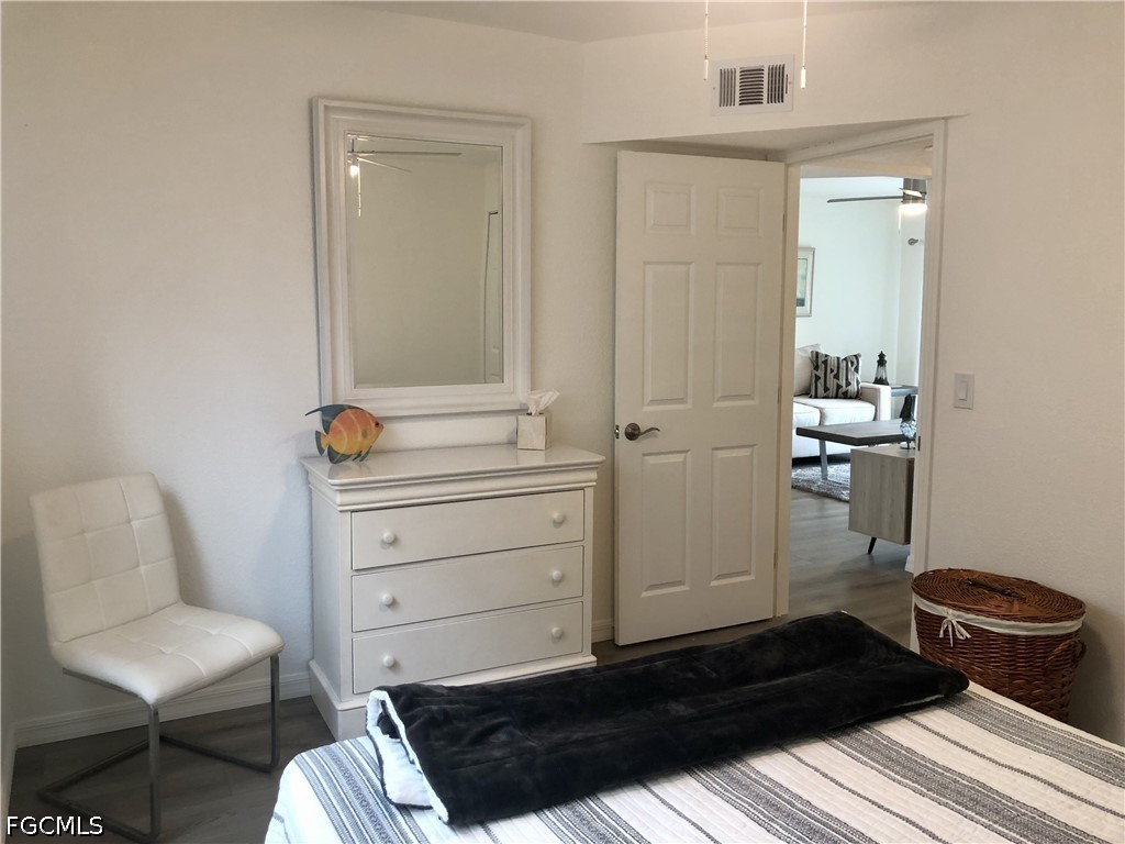16881 Davis Road, Unit 214 Fort Myers, FL 33908 - Photo 21 of 46 a bedroom with a bed and a chair